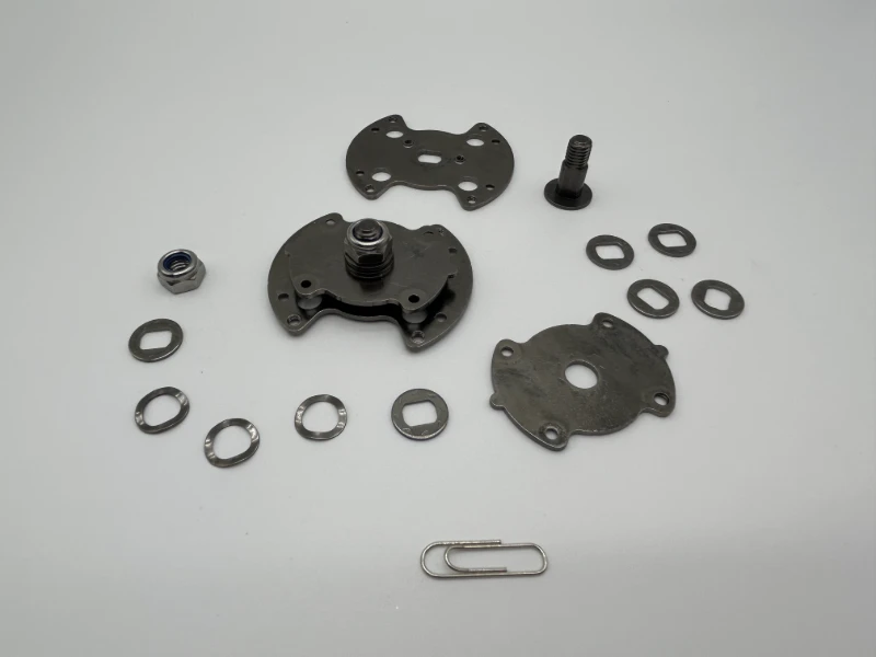 Exploded view of custom SK7 torque hinge with stamped plates washers pivot bolt and lock nut