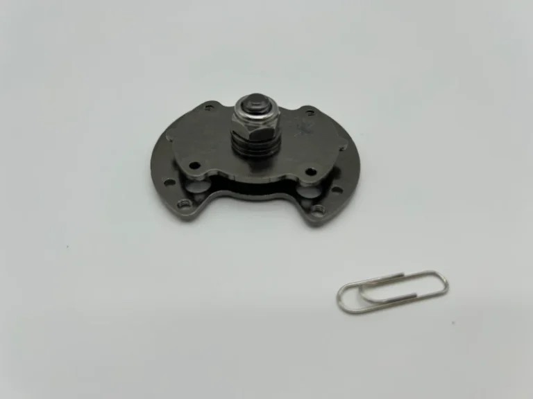 Custom SK7 stamped torque hinge assembly with black nickel plating and central pivot shaft