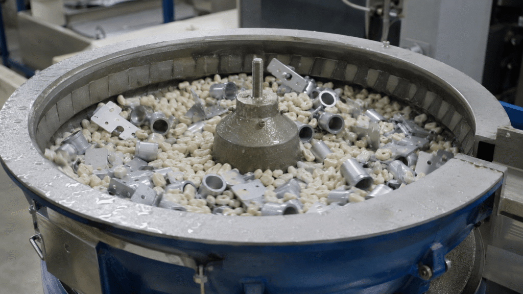 Industrial vibratory bowl processing mixed metal components with ceramic media Title: Vibratory Mass Finishing Process