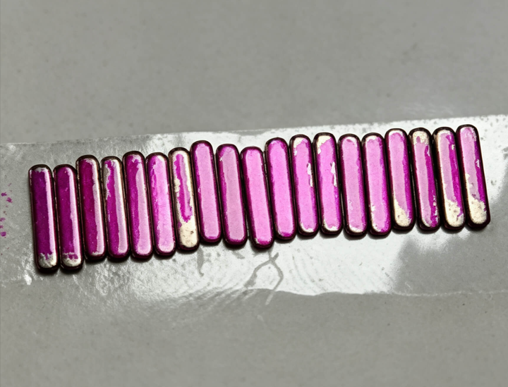34 dyne pen test on miniature stamped metal strips for adhesive assembly