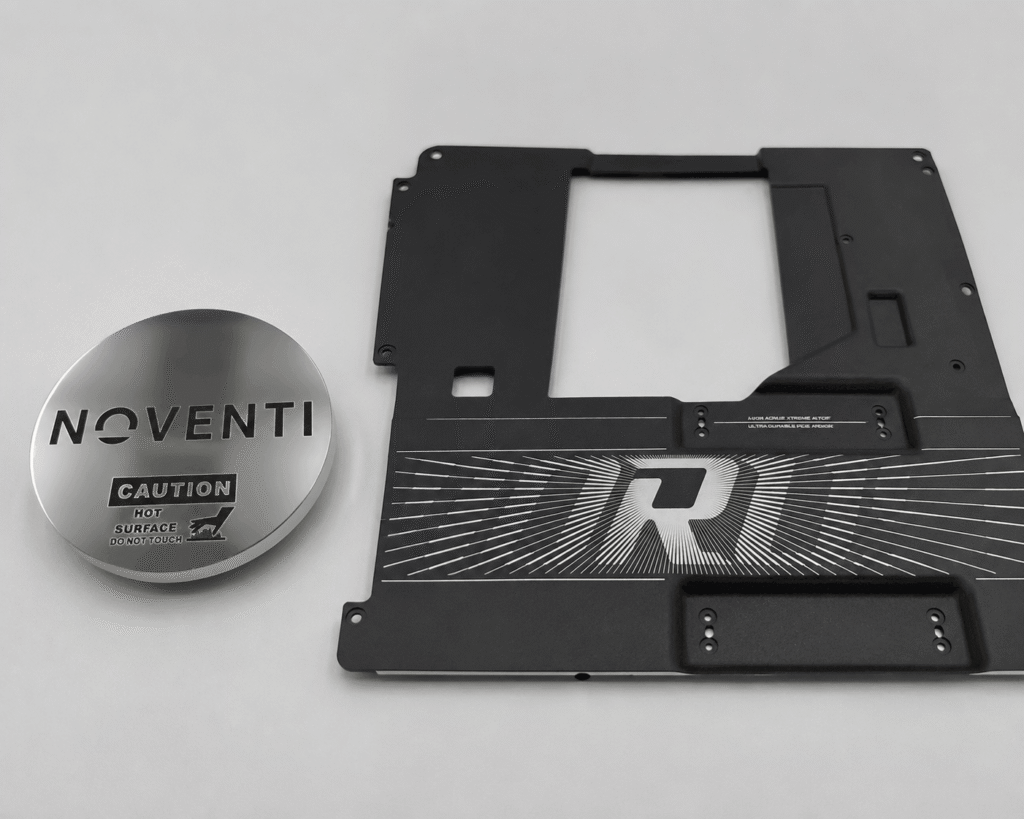 Precision laser engraved metal parts featuring permanent markings and logos on brass and aluminum components for industrial applications.