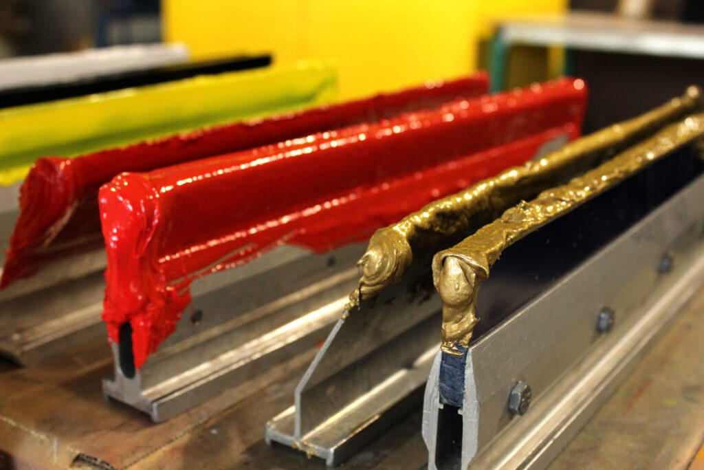 Close-up of screen printing ink on squeegee blades