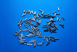 Burr-free miniature stamped metal strips after grinding, electroplating and 34 dyne surface testing
