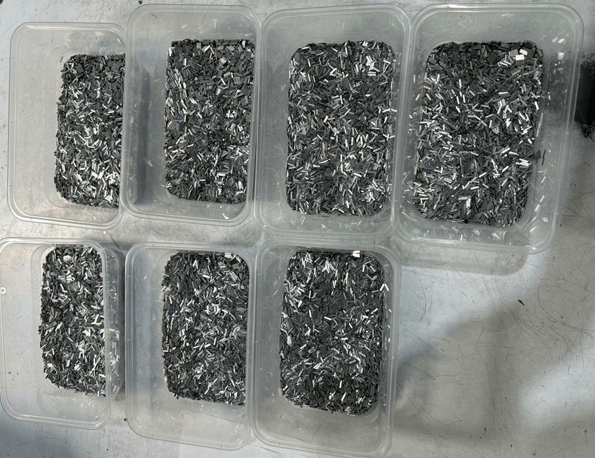 Batches of miniature stamped metal strips prepared for 100 percent final inspection