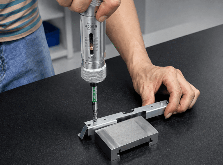 Precision rivet nut torque test using a calibrated torque screwdriver on a sheet metal bracket