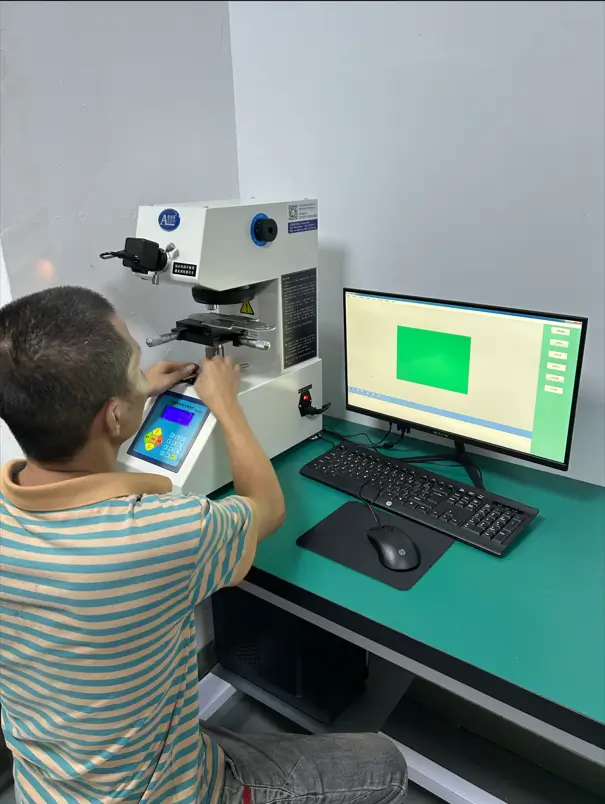 Operator performing hardness inspection on metal parts at Innoway Precision