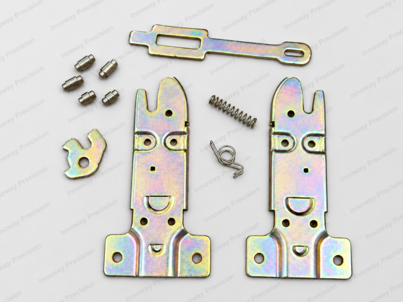 Automotive Trunk Latch – Stamped Parts and Springs Automotive trunk latch connector components including SAPH440 stamped steel plates, connecting bar, turned pins, compression spring and torsion spring.