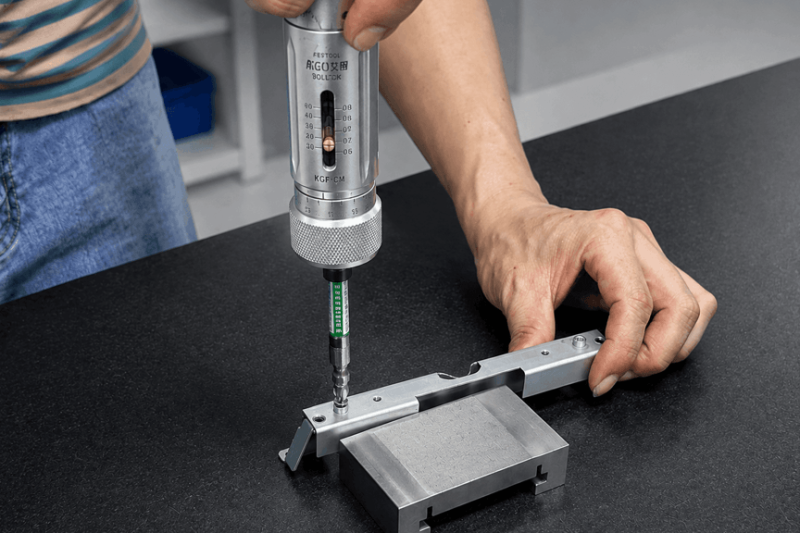 Precision rivet nut torque test using a calibrated torque screwdriver on a sheet metal bracket